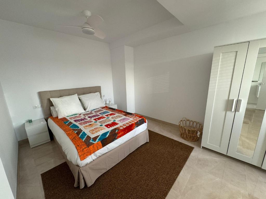 a bedroom with a bed in a white room at Tokyo Rooms Monsul Habitación PREMIUM con baño privado in Almería