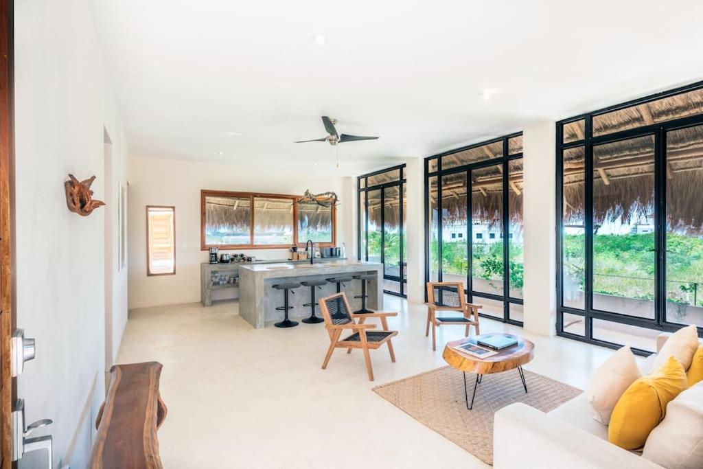 a living room with a couch and a table at Casa Imox Holbox, apartment 1 in Holbox Island