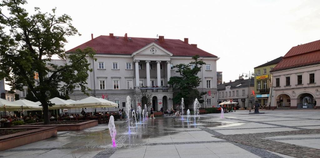 a town square with fountains in front of a building at Gold Glass Jacuzzi Sauna Rynek-Parking in Kielce