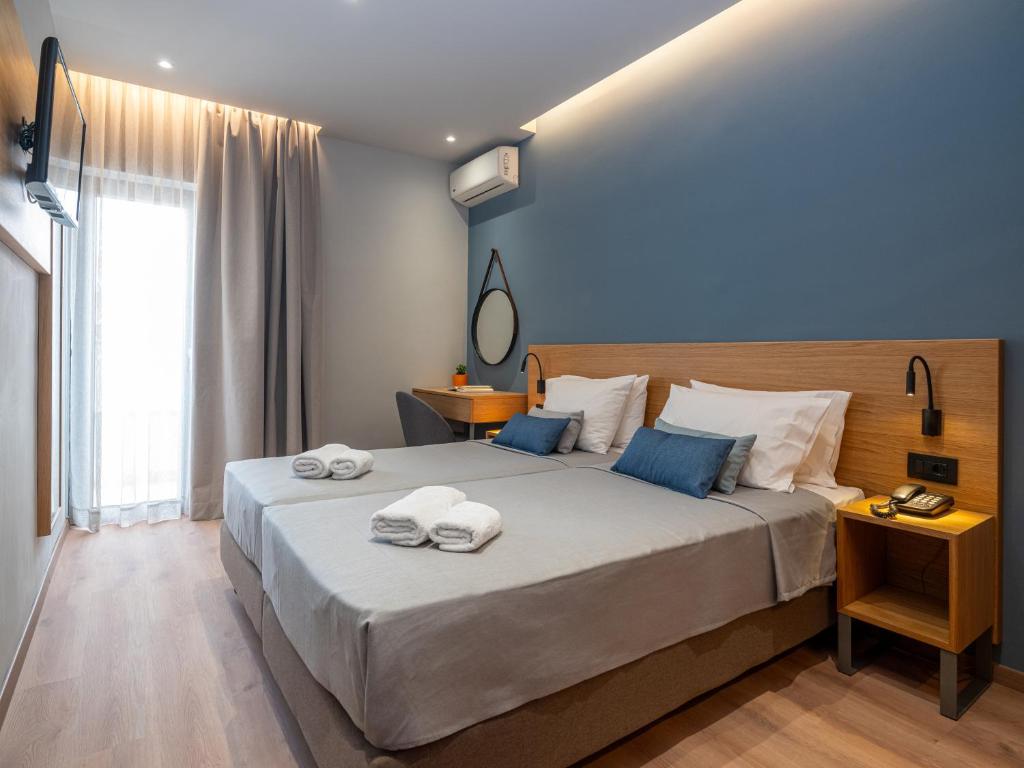 מיטה או מיטות בחדר ב-Athinaiko Hotel
