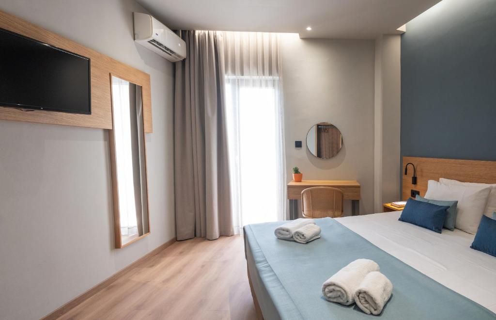 Postel nebo postele na pokoji v ubytování Athinaiko Hotel