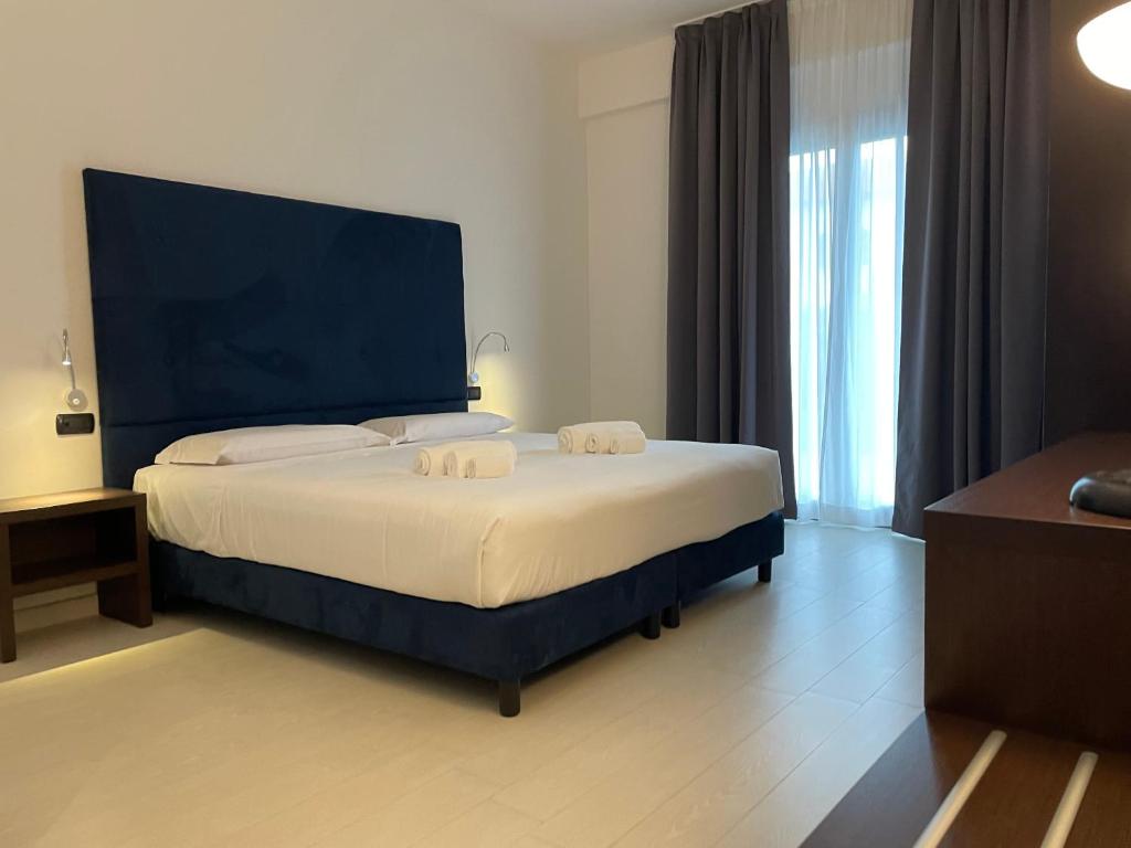 Postel nebo postele na pokoji v ubytování Maestrale Resort Hotel - Grosseto