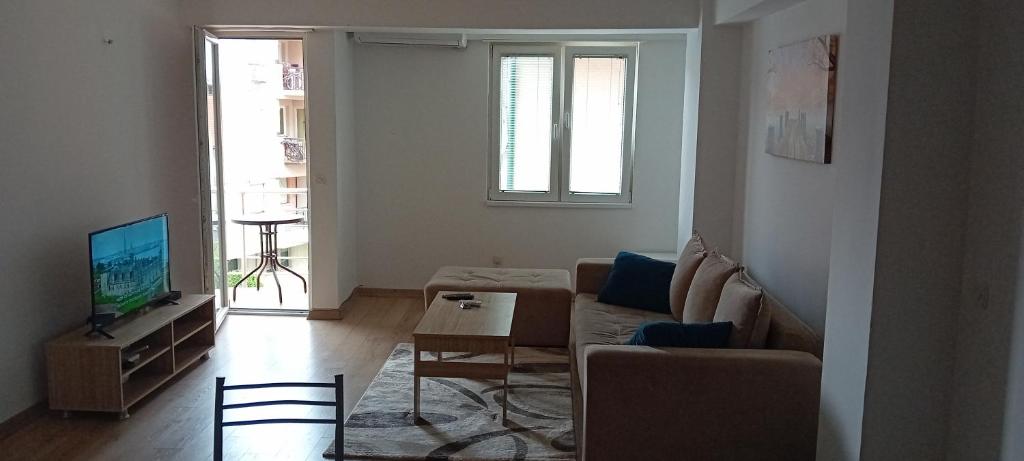 a living room with a couch and a tv at Dea Apartment in Ohrid