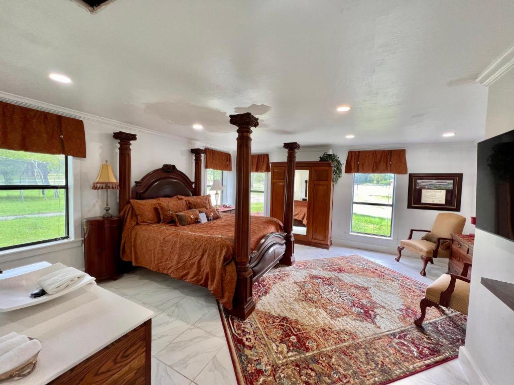 a bedroom with a bed and a desk and chairs at The Cora Suite in Winona