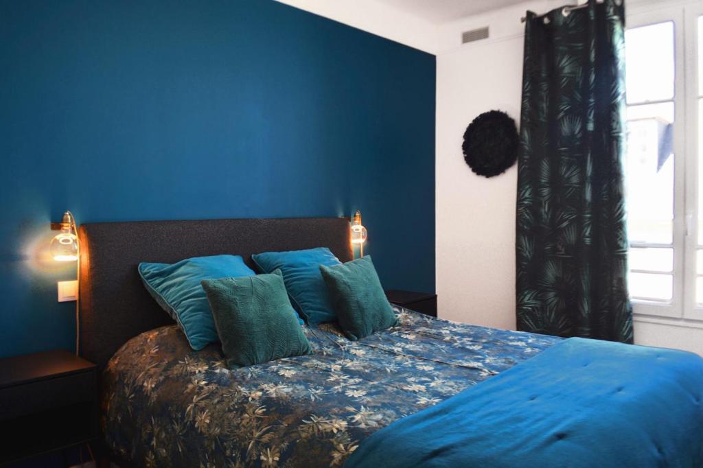 a blue bedroom with a bed with blue walls at SweetHomeVersailles 5mn walk from the Palace in Versailles
