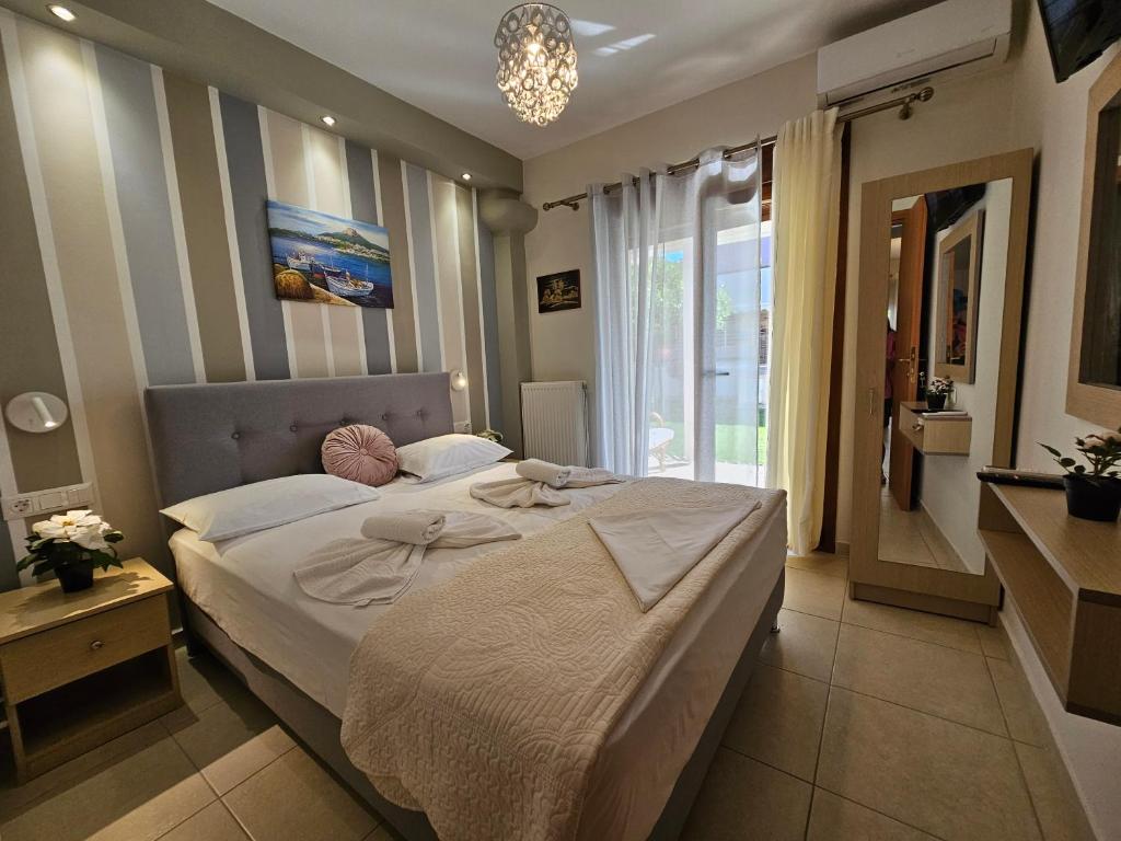 a bedroom with a bed and a large window at Modern Apartment Kallithea 1 in Kallithea Halkidikis