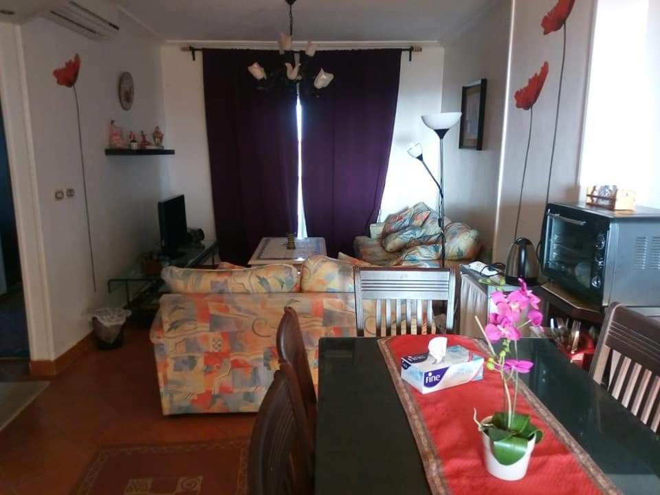 a living room with a couch and a table at شالية مميز للإيجار Porto golf بورتو جولف مارينا in El Alamein
