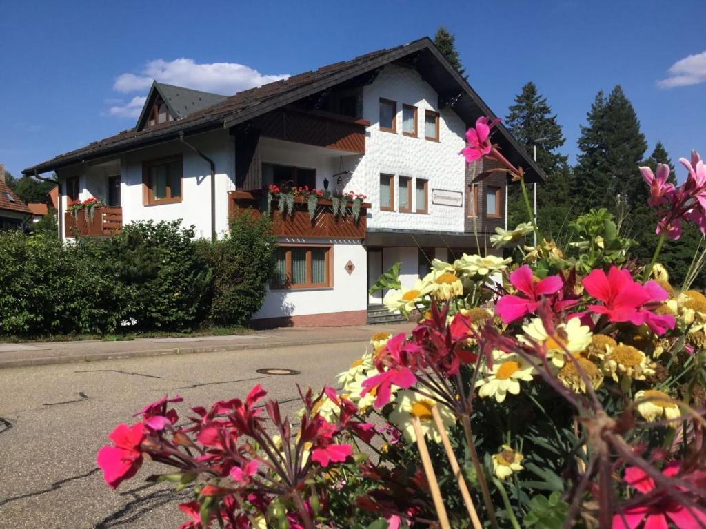 a white house with flowers in front of it at Haus Seiler in Freudenstadt