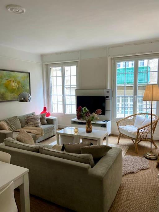 un salon avec un canapé et une télévision dans l'établissement T4 lumineux et spacieux Intra-Muros proche plages, à Saint-Malo