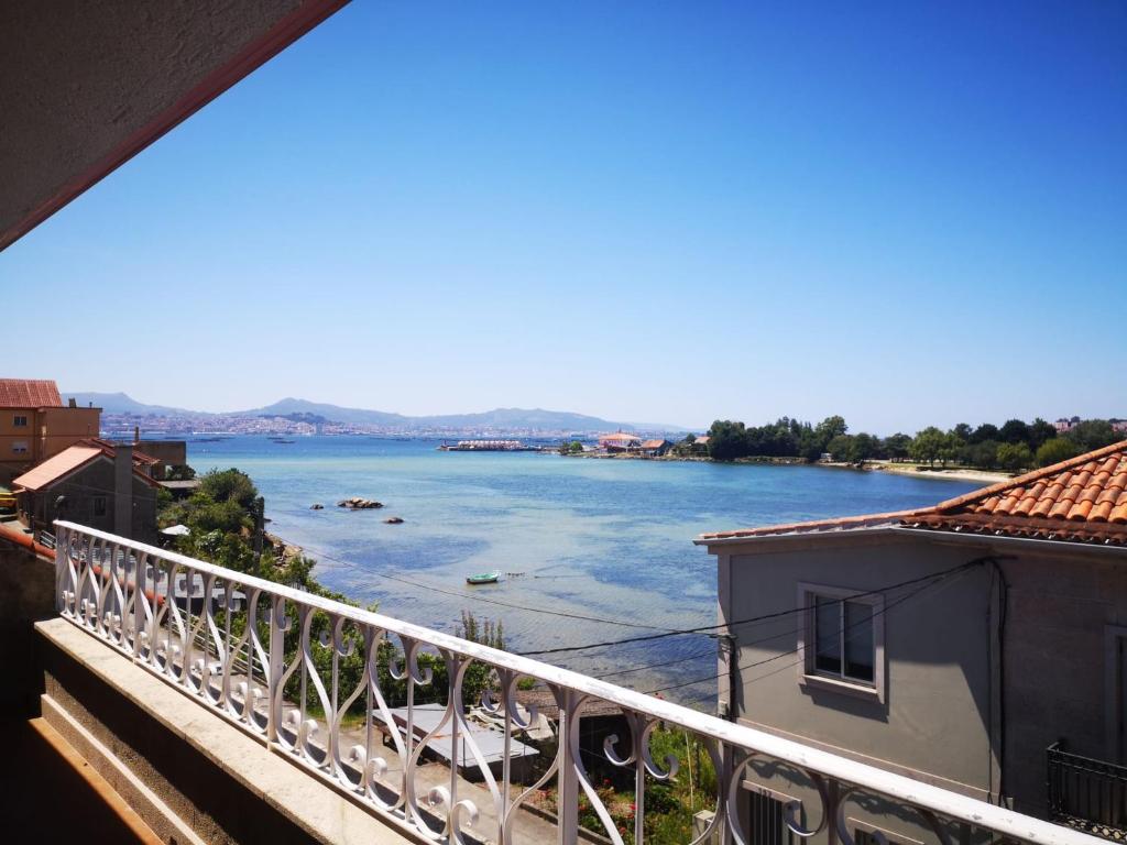 a view of a river from a balcony at Villa Papona - Ático ,parking in Moaña