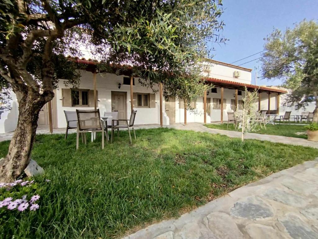 a house with a table and chairs in the yard at Almmos Mezzanine Apartments 2 in Kalamaki Heraklion