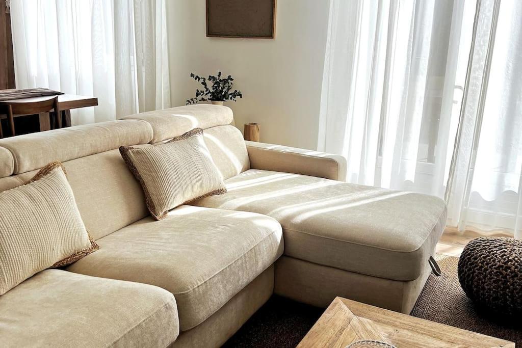 a living room with a couch and a table at L'Aparté à 5min de la plage de Hardelot in Neufchâtel-Hardelot