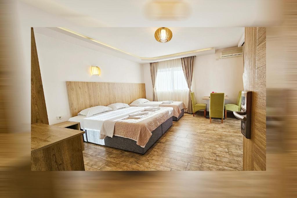 a hotel room with two beds and a table at Villa Montemaris Budva in Budva
