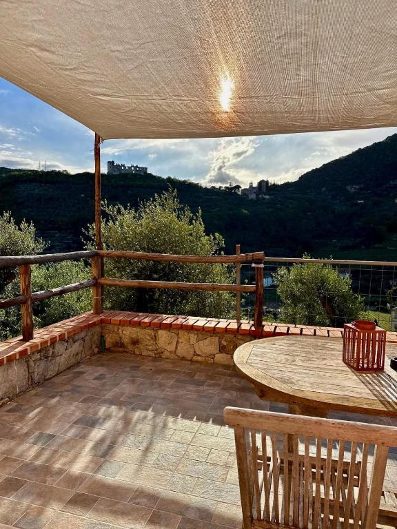 a patio with a wooden table and a wooden fence at Affittacamere Ca' Baldo in Finale Ligure
