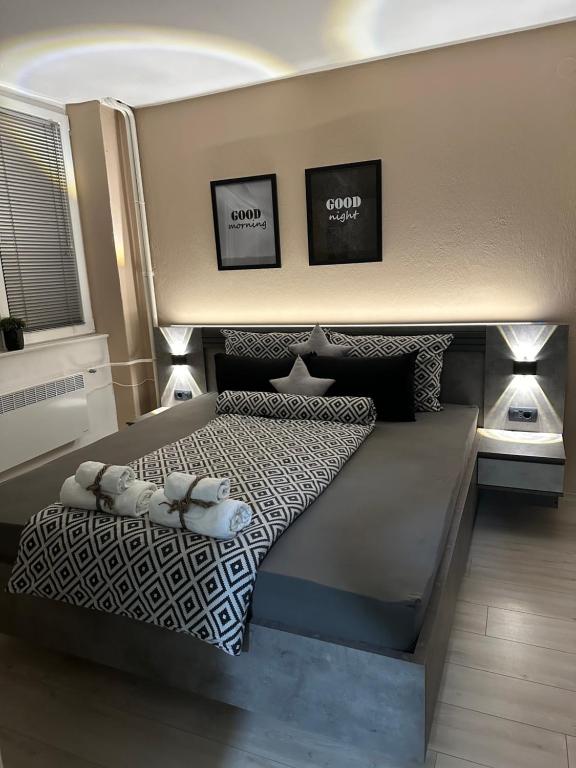 a bedroom with a bed with two pillows on it at NOA Luxury Apartment in Bitola