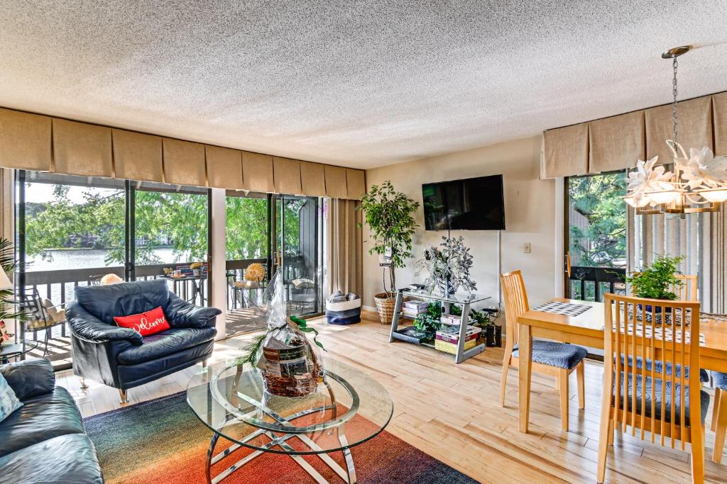 a living room with a glass table and a dining room at Lakeview Condo with Resort Pool 2 Miles to Golf! in Pinehurst