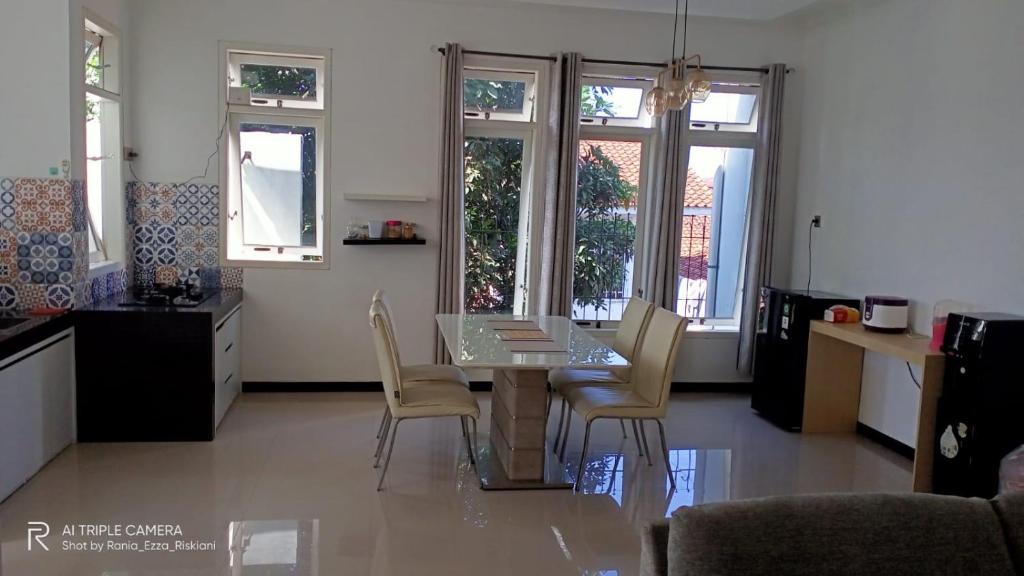 a kitchen and dining room with a table and chairs at HOMESTAY KIKA SYARIAH PURWOKERTO in Purwokerto