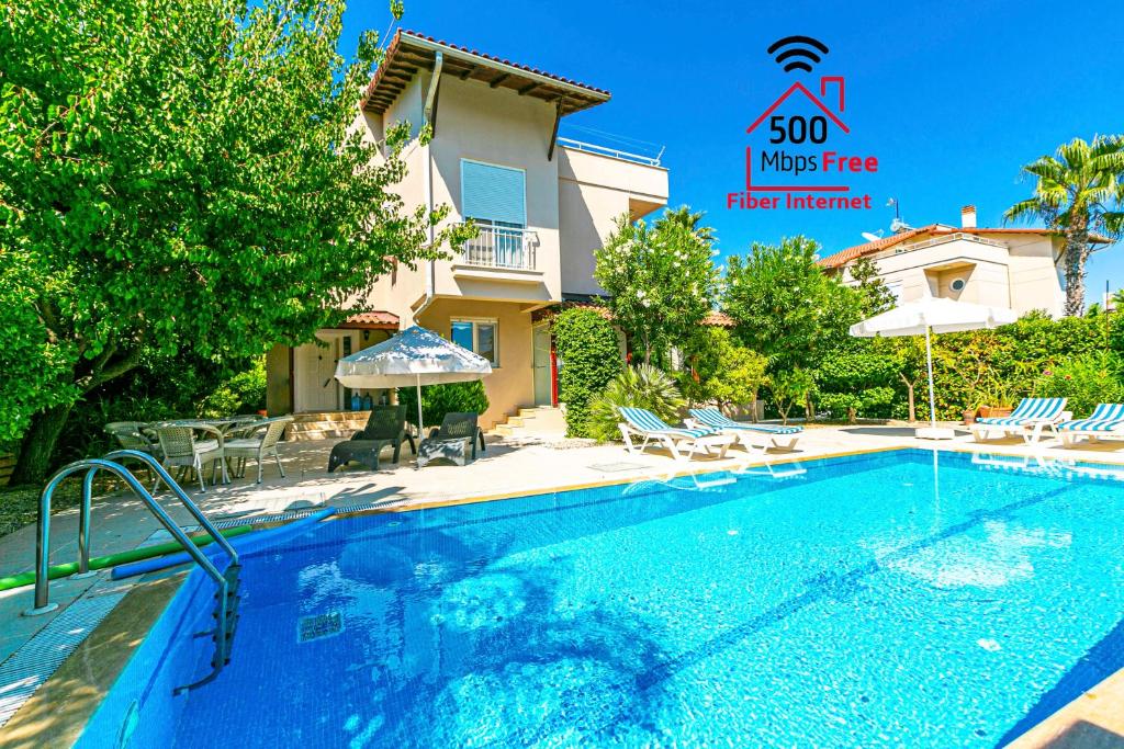 a swimming pool in front of a villa at Paradise Town Villa Beldora 500 MBPS free wifi in Belek