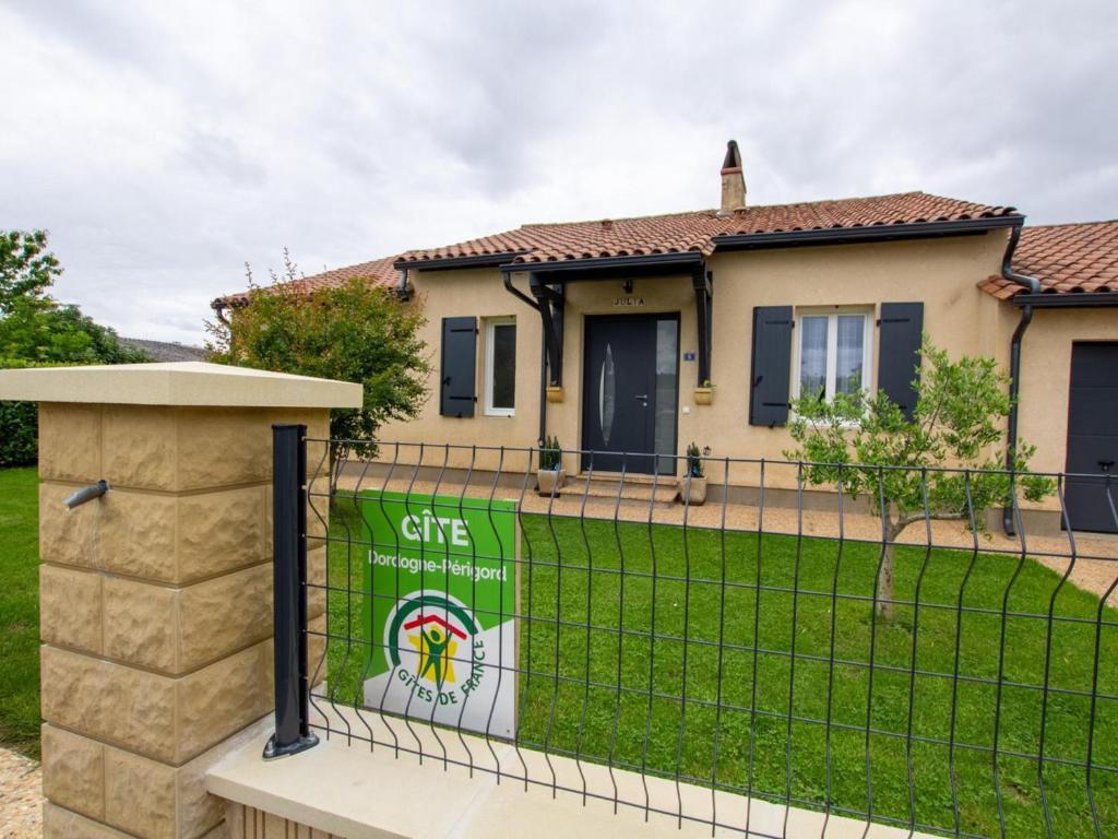 a house with a gate with a sign on it at Maison Familiale au Calme avec Ping-Pong, Baby-Foot et Proximité Sites Préhistoriques - FR-1-616-339 in Le Bugue