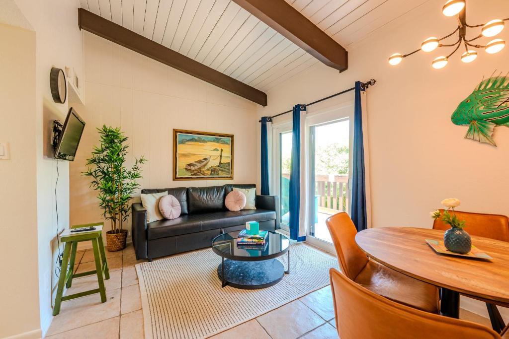 a living room with a couch and a table at Seagulls Serenade Cozy 1BR Hideaway near Beach 206 in South Padre Island