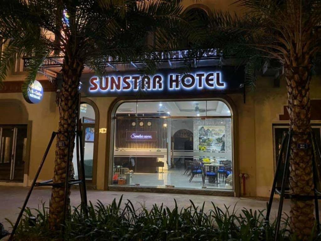 a sun star hotel with a palm tree in front of it at Sunstar Hotel in Ha Long