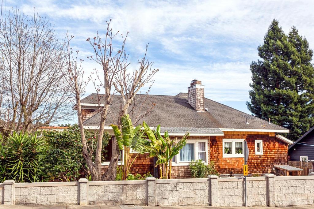 a brick house with a fence in front of it at Beautiful Spacious Victorian Garden Oasis Central, Gated, Deck, BBQ in San Rafael