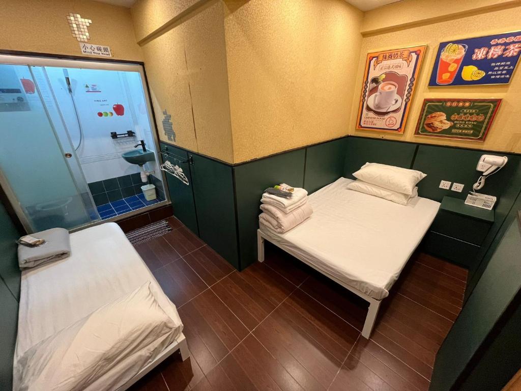 A bed or beds in a room at Just Inn on Nathan Road