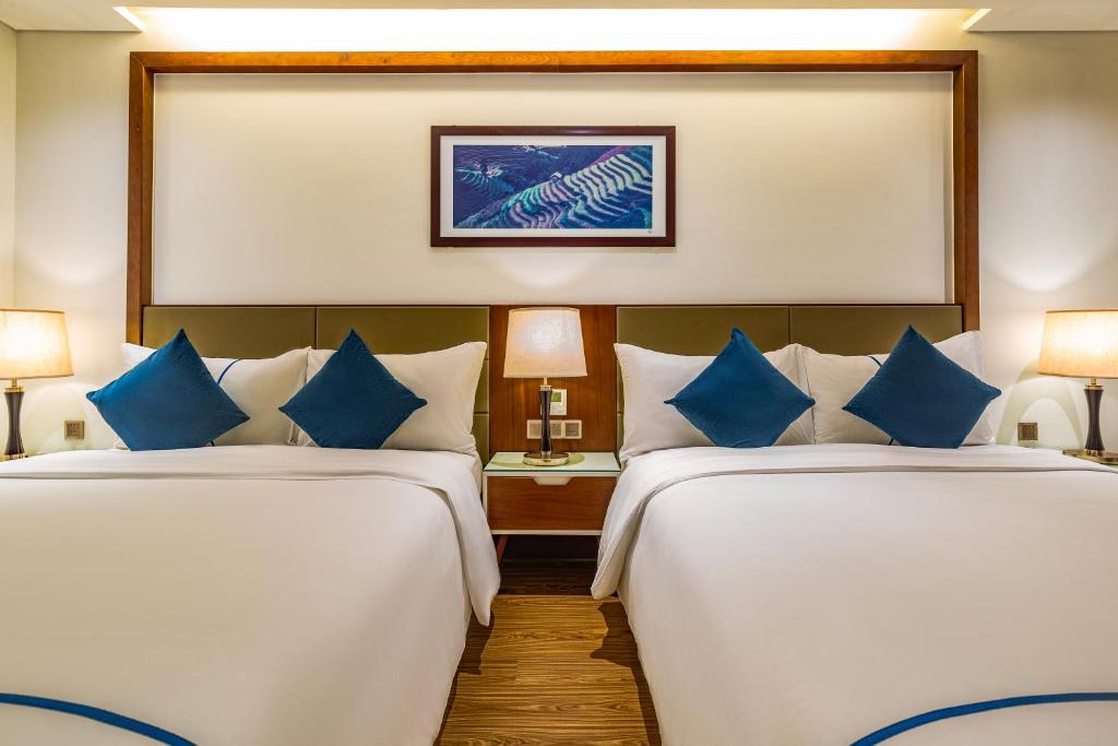 Postel nebo postele na pokoji v ubytování Pavilion Hotel Da Nang