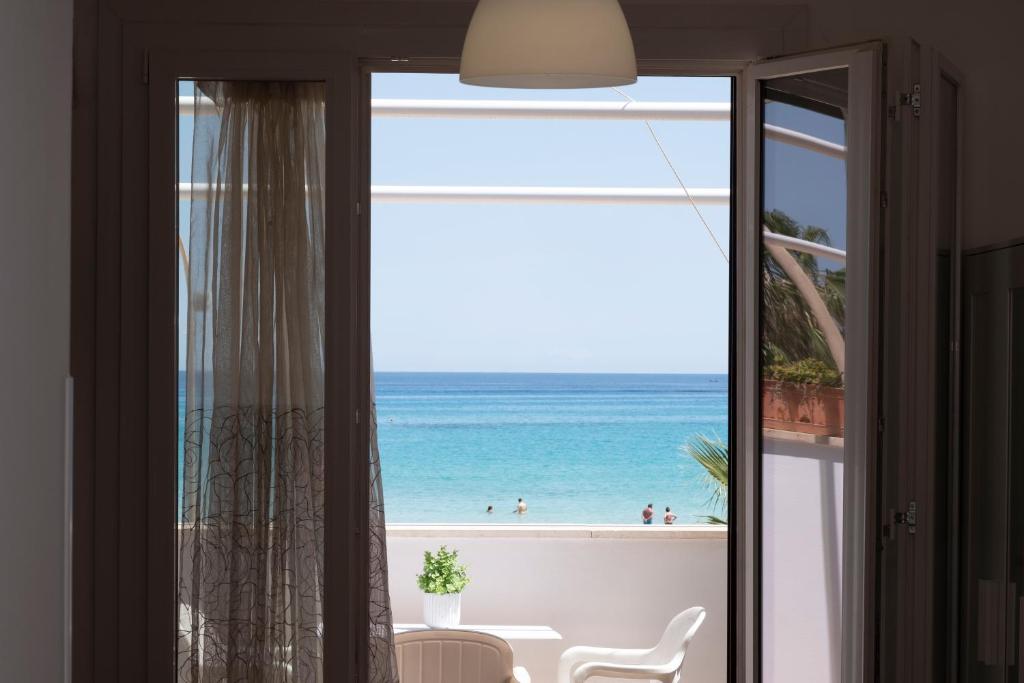 a view of the beach from a room with a window at Appartamento Conturrana Sul Mare in San Vito lo Capo