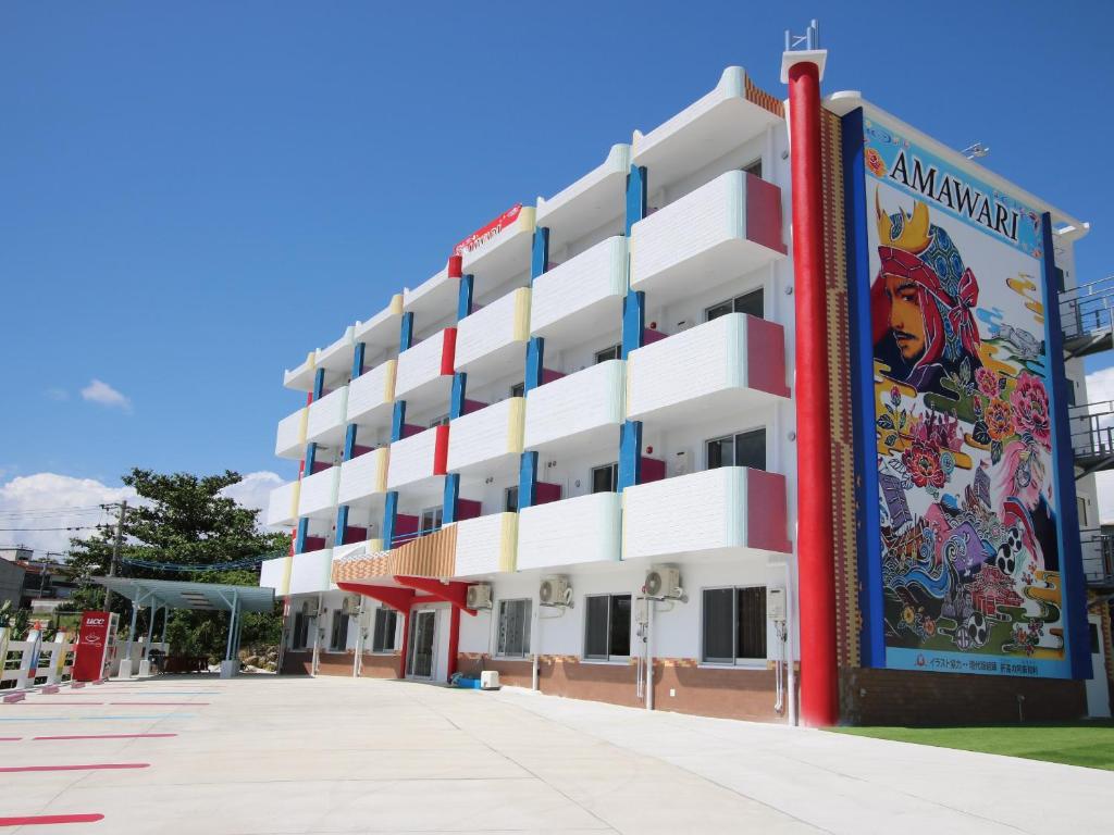 an apartment building with a mural on the side at AMAWARI HOTEL -SEVEN Hotels and Resorts- in Uruma