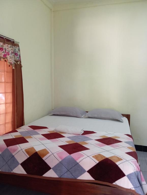 Postel nebo postele na pokoji v ubytování Pedek Homestay