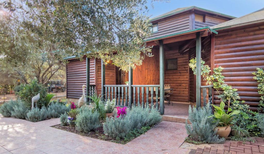 a wooden cabin with plants in front of it at Lavender In The Mountains in Ramot Naftali