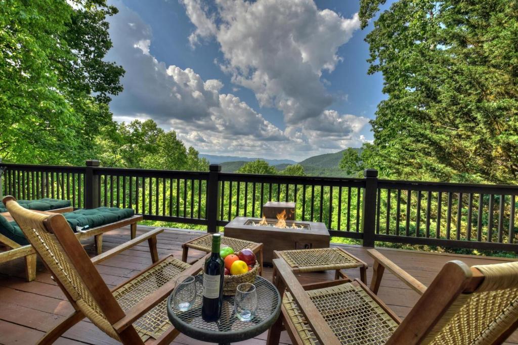a deck with chairs and a table with a grill at Starlight Mountain in Ellijay