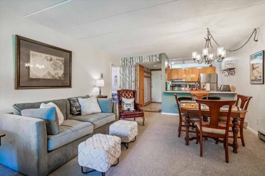 a living room with a couch and a table at Pinnacle E17 in Killington