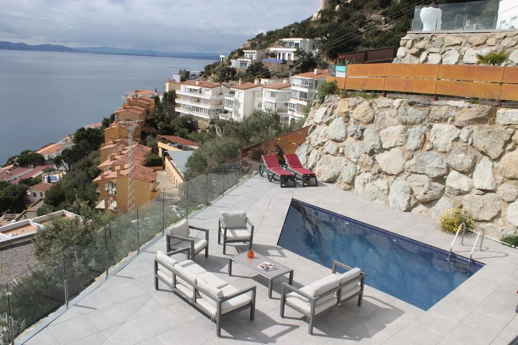 una piscina con sillas y vistas al agua en Agi Joan Margarit, en Roses