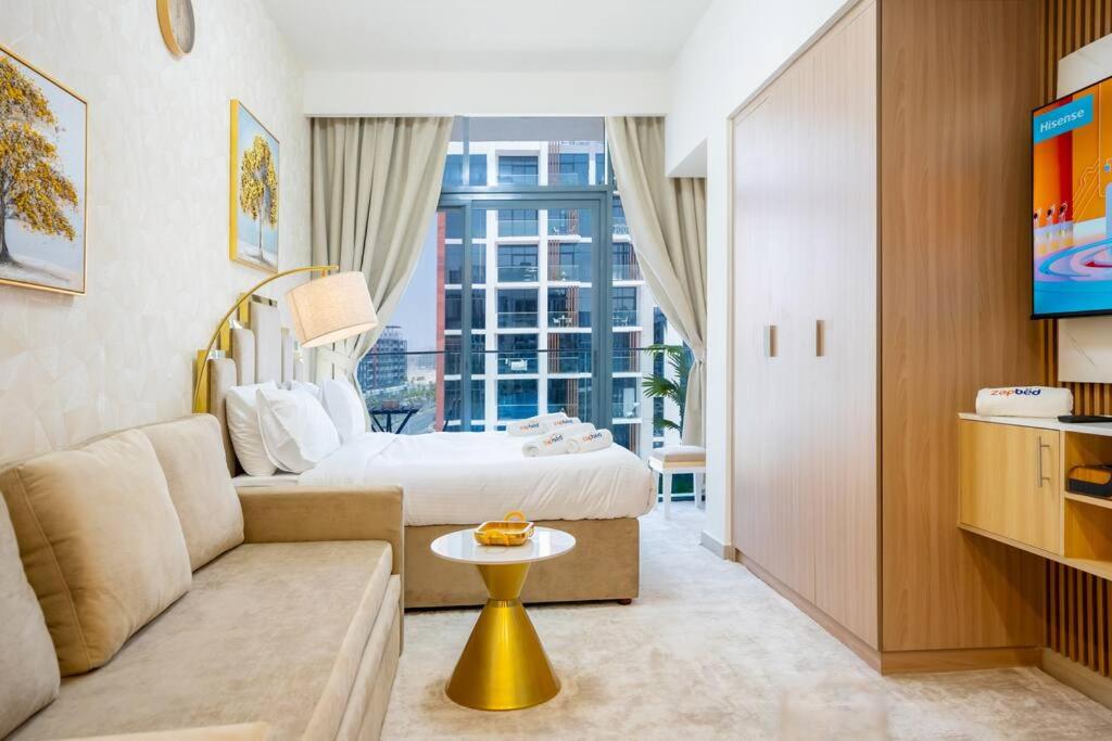 une chambre d'hôtel avec un lit et un canapé dans l'établissement Zapbed House - AZIZI RIVIERA, à Dubaï