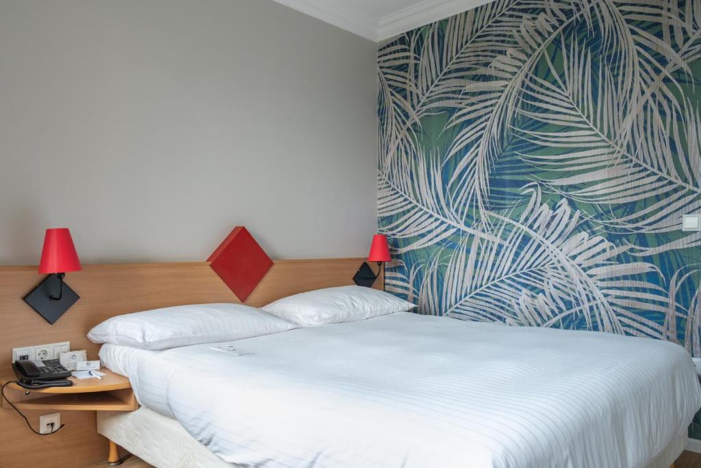 Postel nebo postele na pokoji v ubytování Hotel Parc Belle-Vue