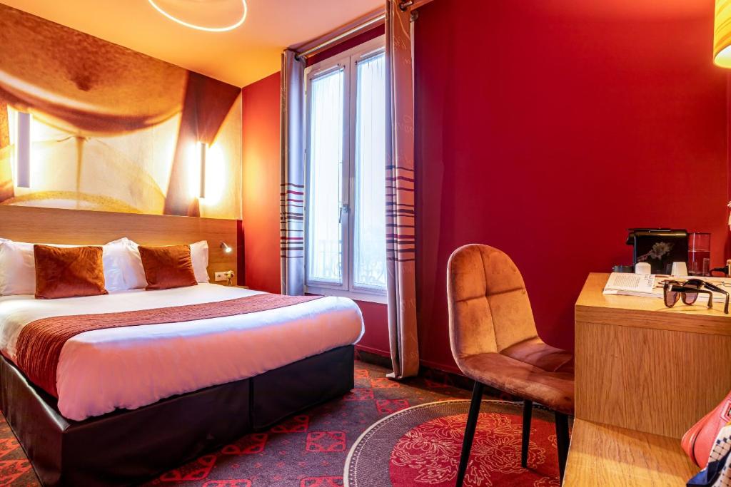 a bedroom with a bed and a desk and a chair at Hotel Ariane Montparnasse by Patrick Hayat in Paris