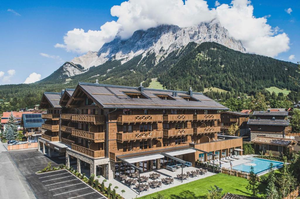 a hotel with a mountain in the background at Bergresort Zugspitze Ehrwald by ALPS RESORTS in Ehrwald