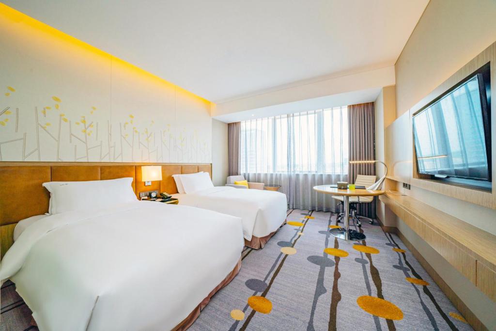 Postel nebo postele na pokoji v ubytování Holiday Inn Shaoguan Downtown by IHG
