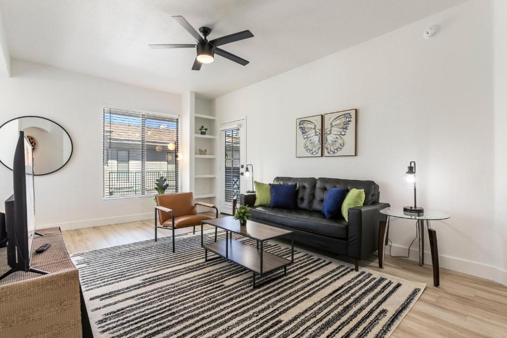 a living room with a couch and a ceiling fan at 3BR CozySuites at Kierland Commons with pool #12 in Scottsdale