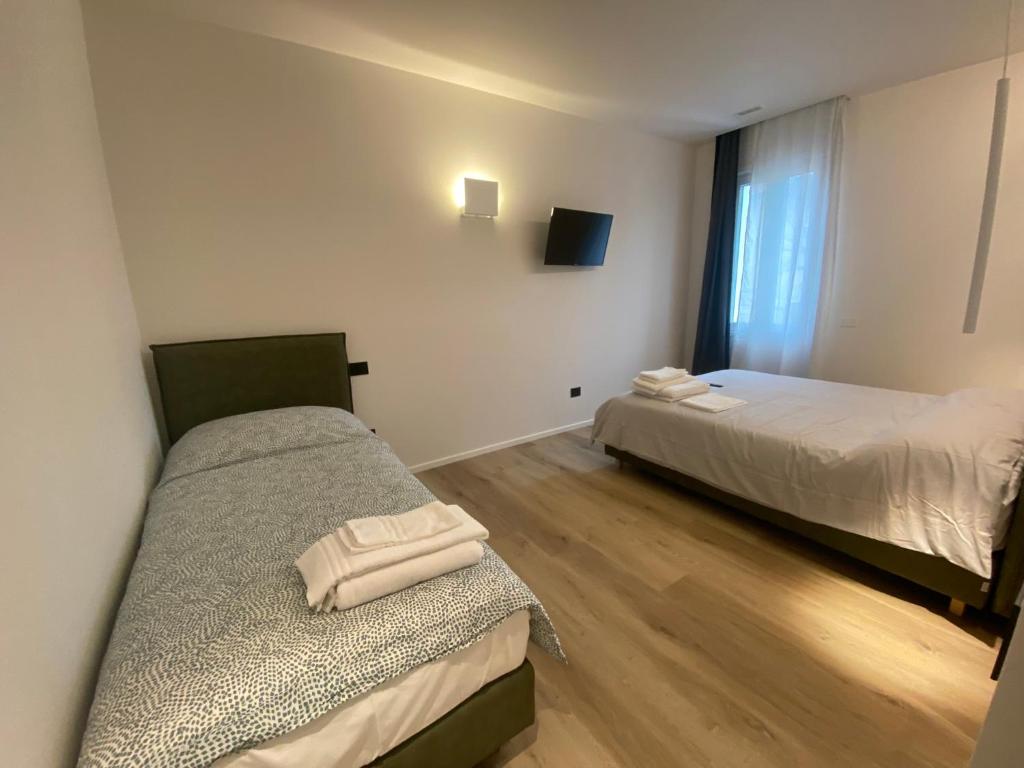 Postel nebo postele na pokoji v ubytování Prato della Valle Apartments