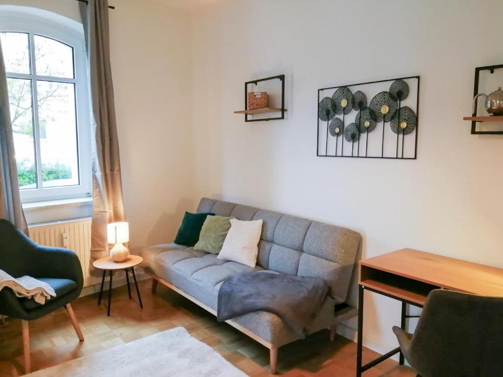 a living room with a couch and a table at ThüringenApartments Südstadt in Saalfeld