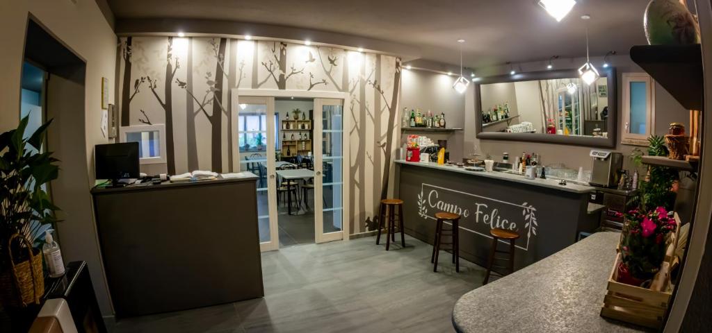 a hair salon with a bar and a counter and chairs at Agriturismo Parco Campofelice in Lombardore