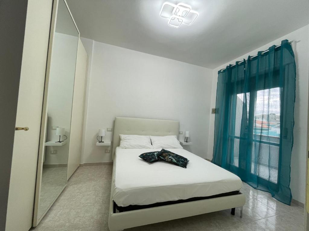 a bedroom with a bed with a mirror and a window at Alcione113 Apartment in Francavilla al Mare