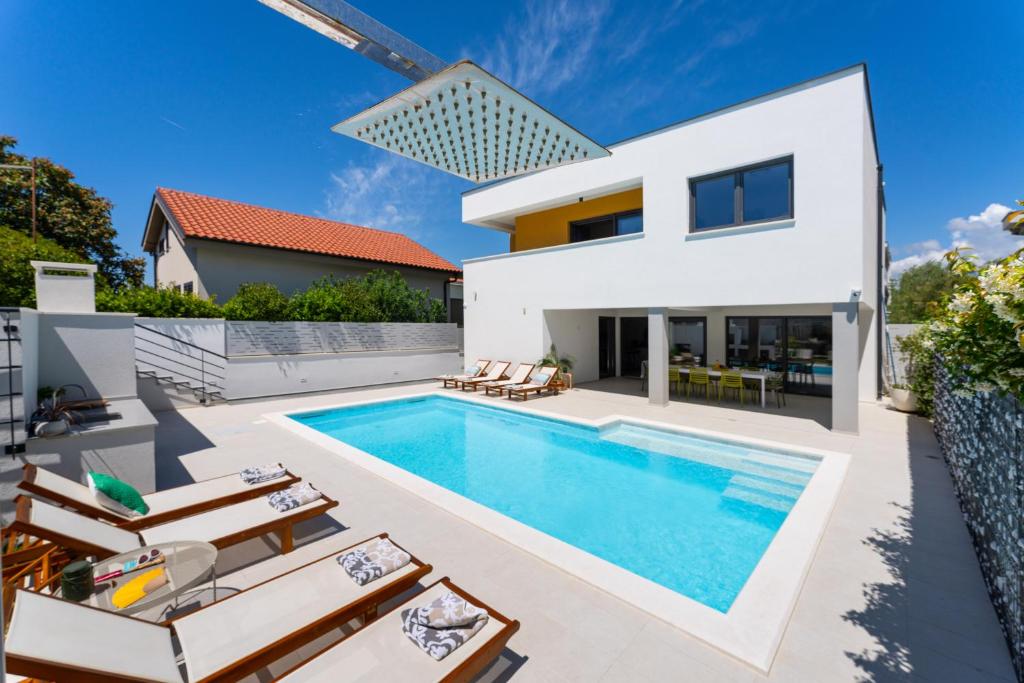 a swimming pool in the backyard of a villa at D Marine villa in Bibinje