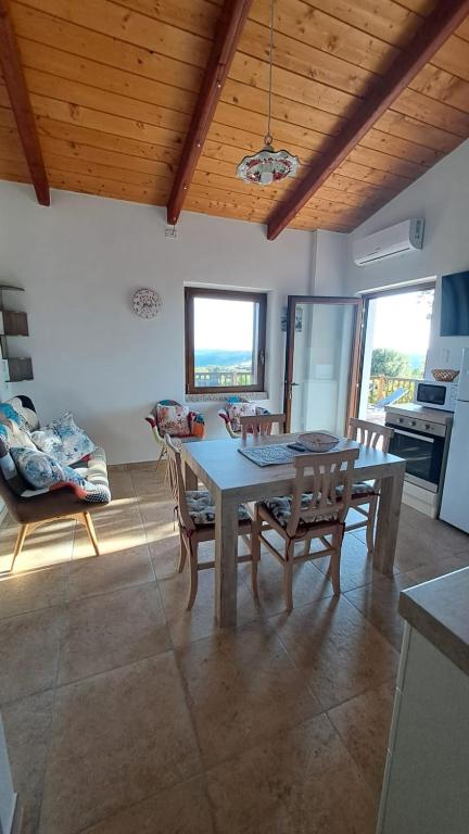 a kitchen and dining room with a table and chairs at Villa DEA in Aglientu