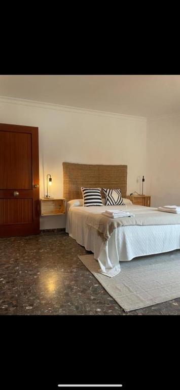 a bedroom with a bed with a zebra pillow on it at Hostal Paquito in Vejer de la Frontera