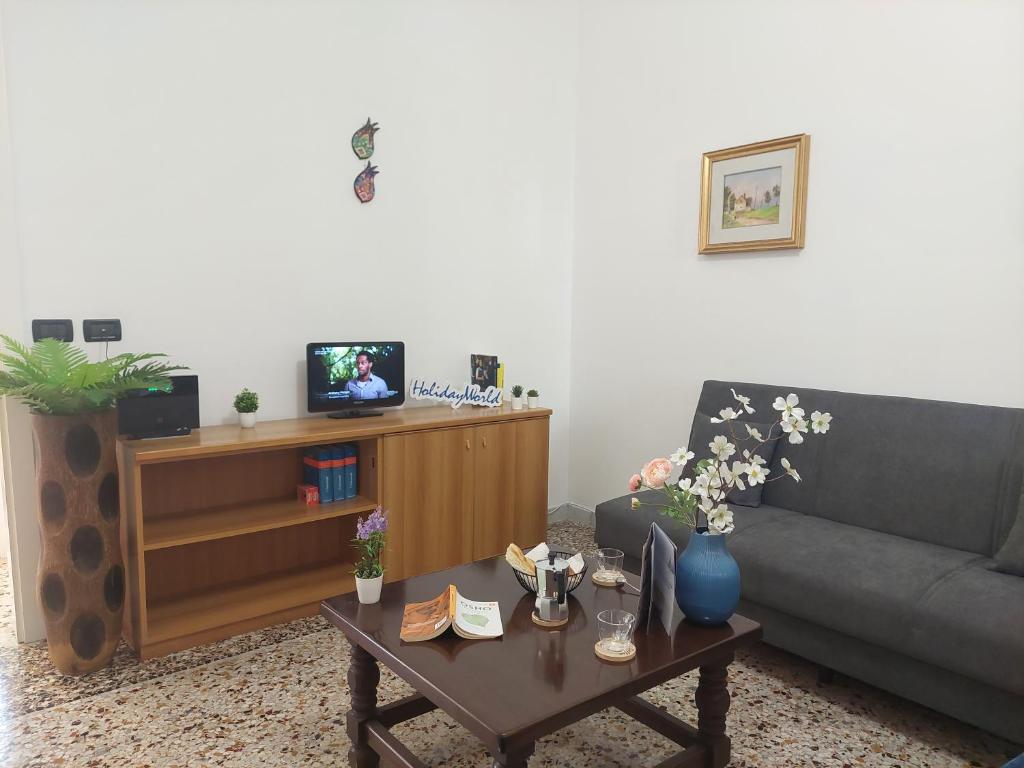 a living room with a couch and a coffee table at Casa Tulipani by Holiday World in Savona