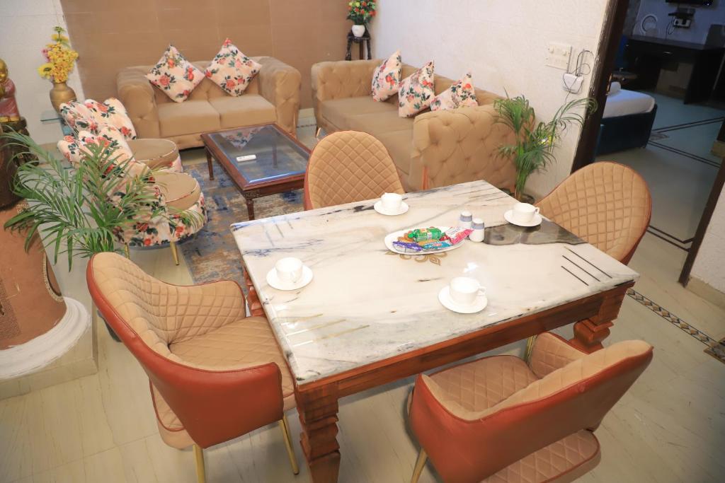 a table and chairs in a living room at Fortune Home Service Apartment 3Bhk , D-198 Saket in New Delhi